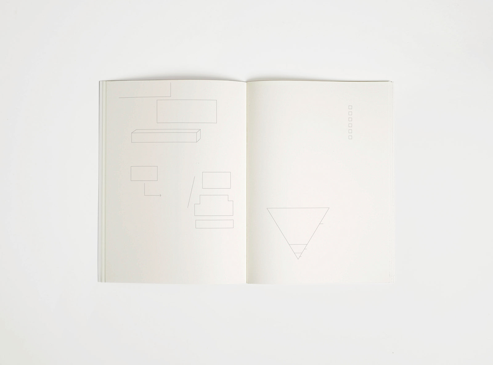 Open notebook edition julie joliat x studio playground with white pages on a white background, with scribbles printed on it.