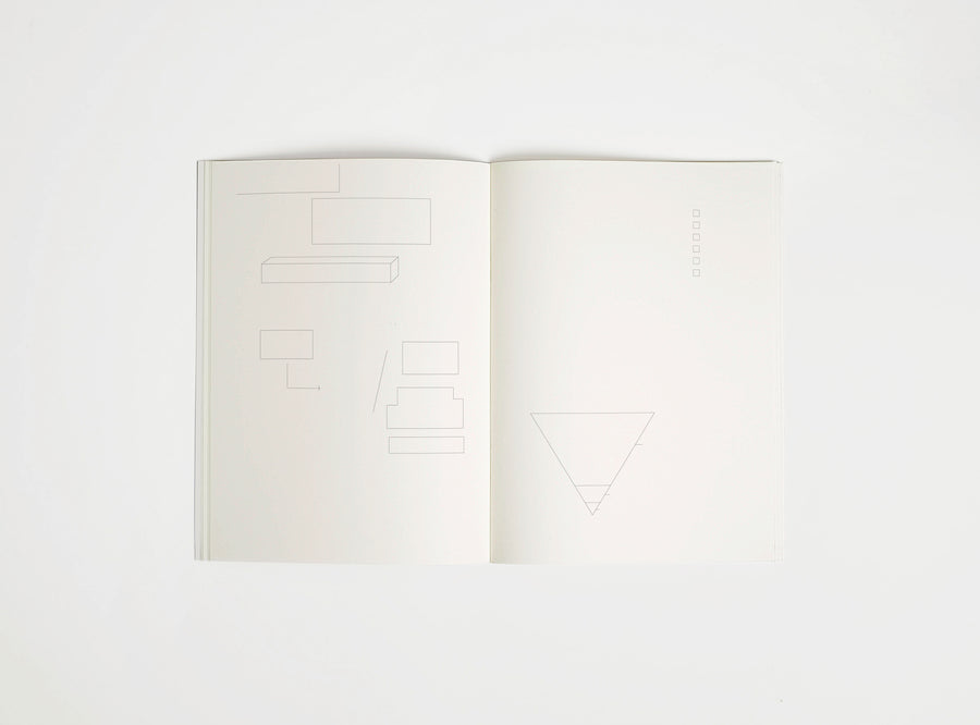 Open notebook edition julie joliat x studio playground with white pages on a white background, with scribbles printed on it.