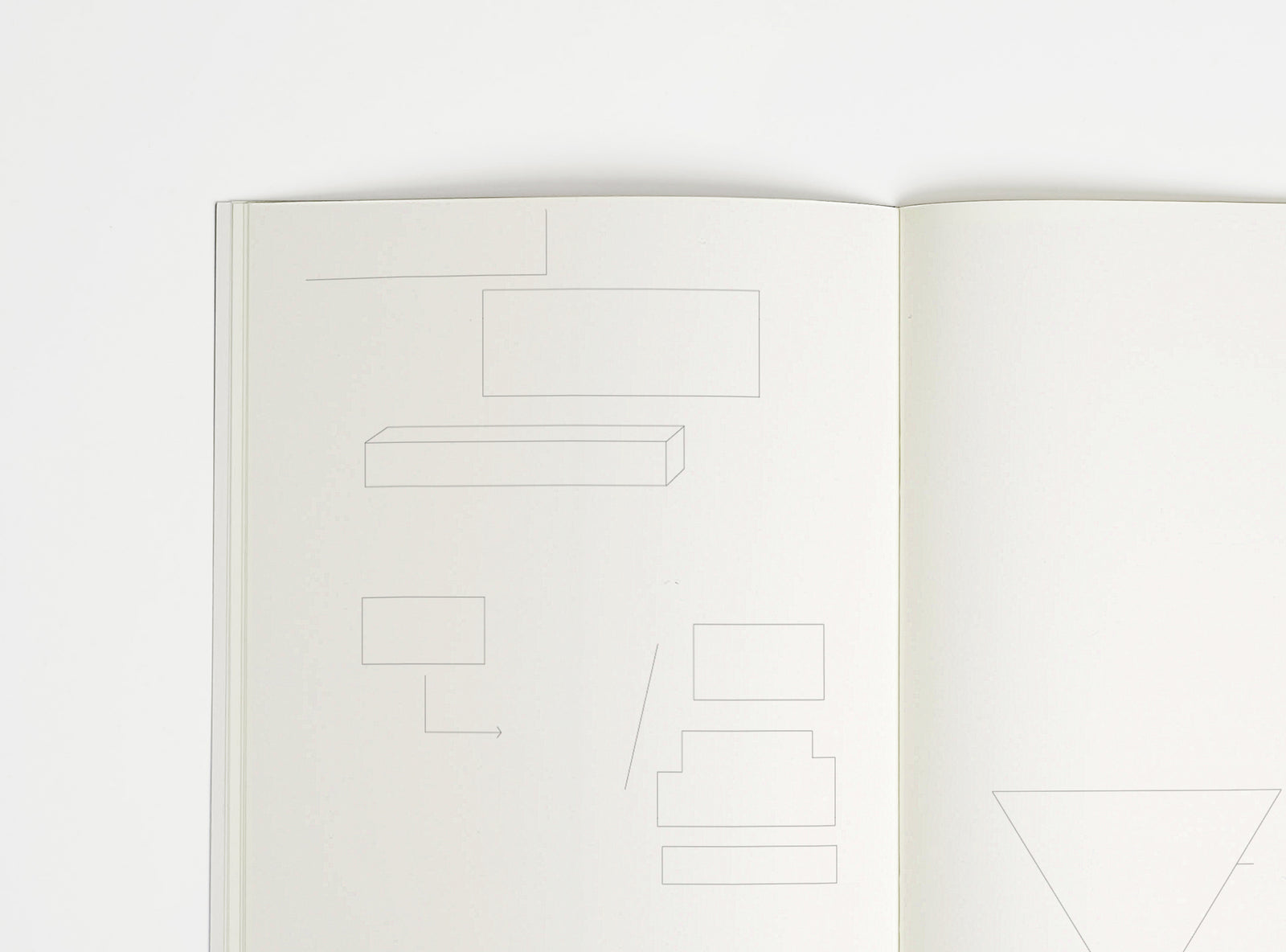 Open notebook edition julie joliat x studio playground with white pages on a white background, with scribbles printed on it.