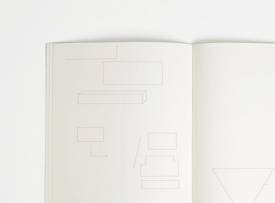 Open notebook edition julie joliat x studio playground with white pages on a white background, with scribbles printed on it.