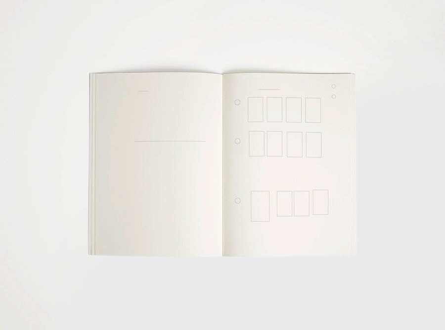 Open notebook edition julie joliat x studio playground with white pages on a white background, with scribbles printed on it.