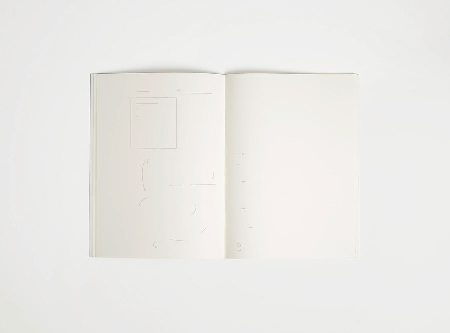 Open notebook edition julie joliat x studio playground with white pages on a white background, with scribbles printed on it.