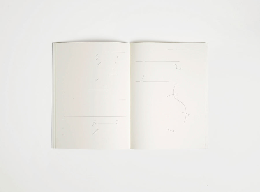 Open notebook edition julie joliat x studio playground with white pages on a white background, with scribbles printed on it.