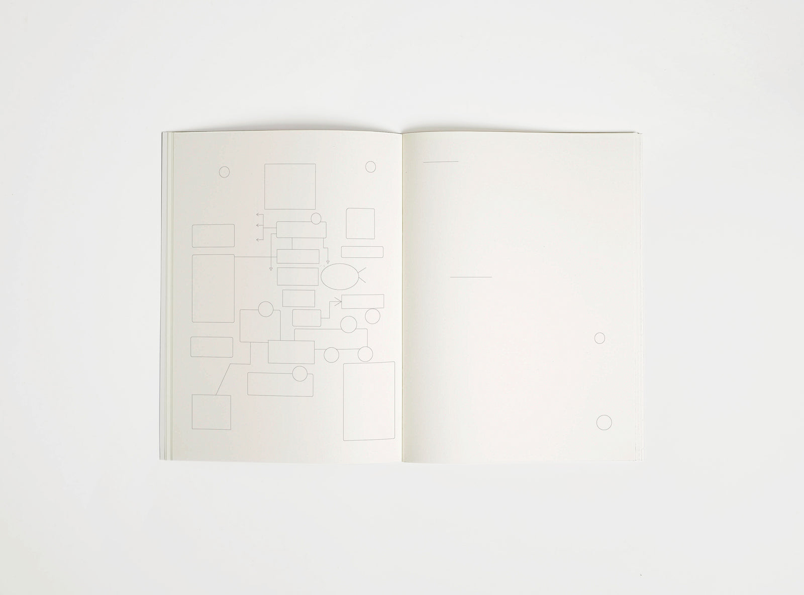 Open notebook edition julie joliat x studio playground with white pages on a white background, with scribbles printed on it.