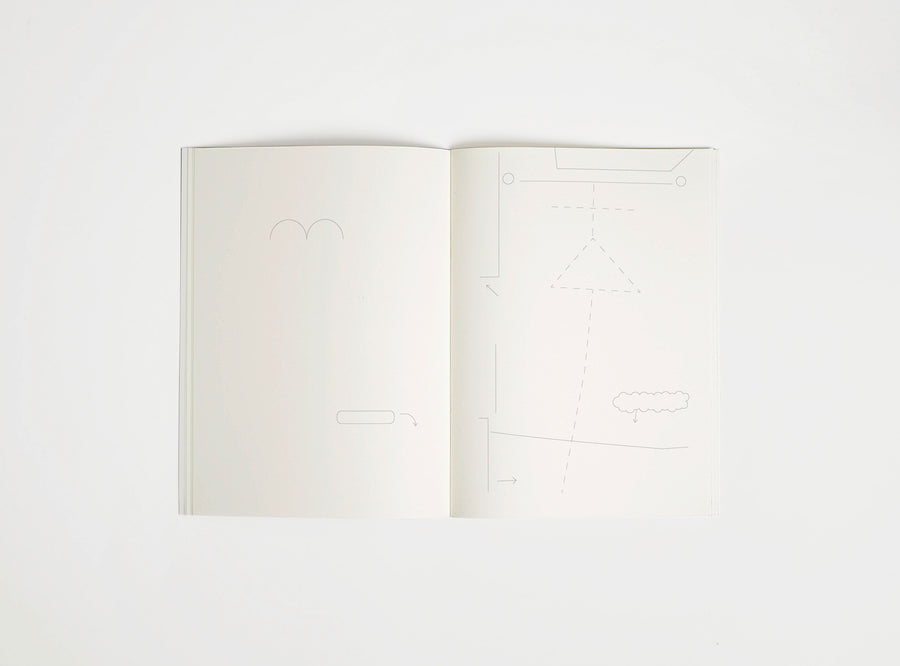 Open notebook edition julie joliat x studio playground with white pages on a white background, with scribbles printed on it.