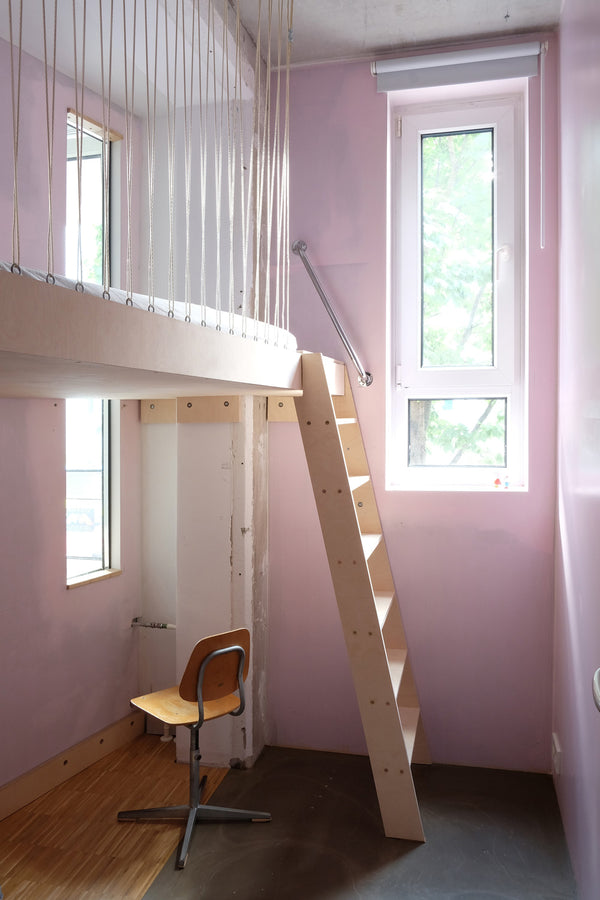 small pink kid's room with high bed