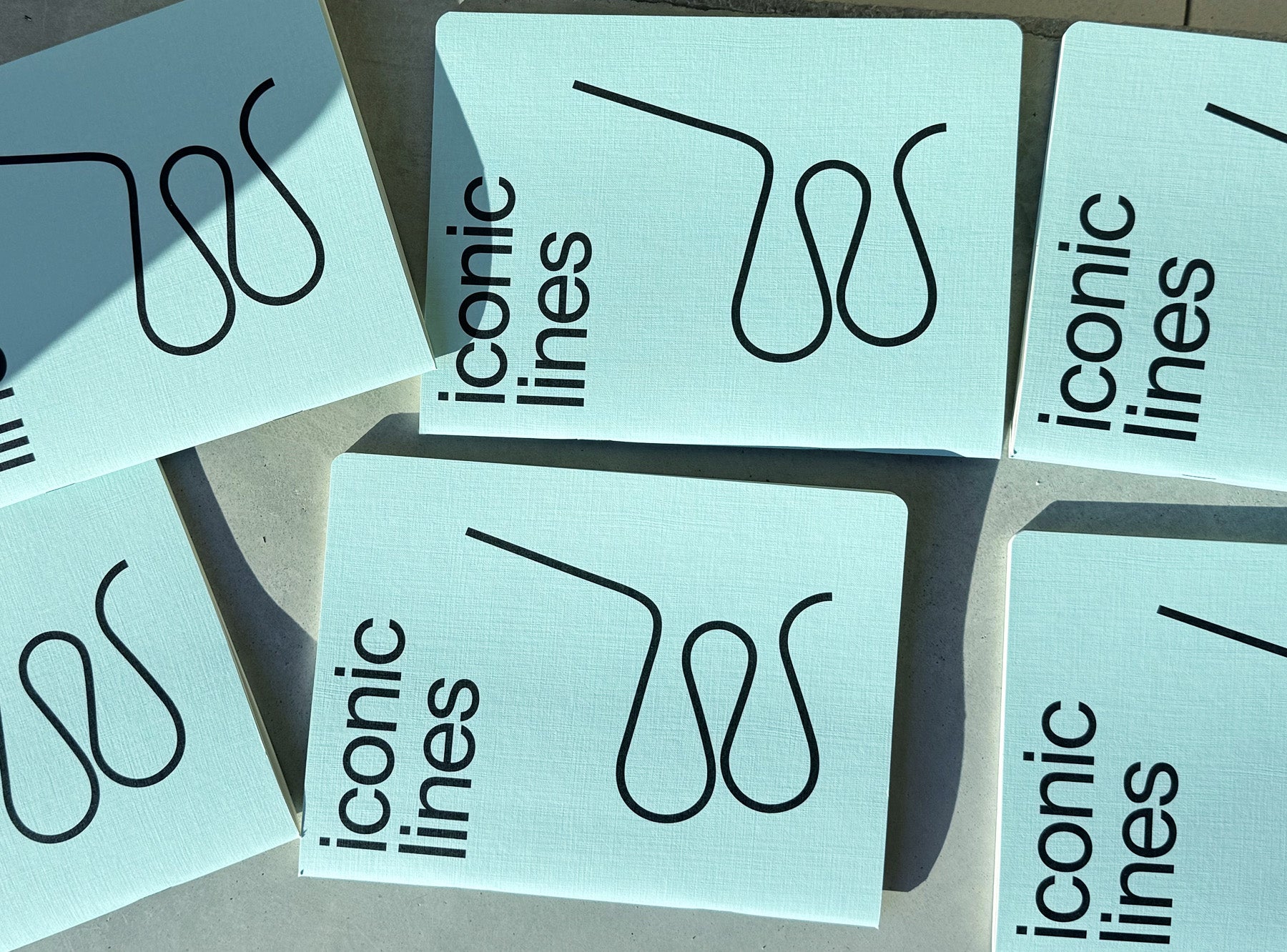 Iconic lines notebooks, 6 light blue cover  on beton background 