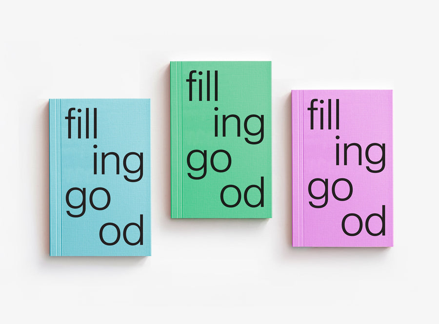 Three notebooks with text 'filling good' in different colors on a white background