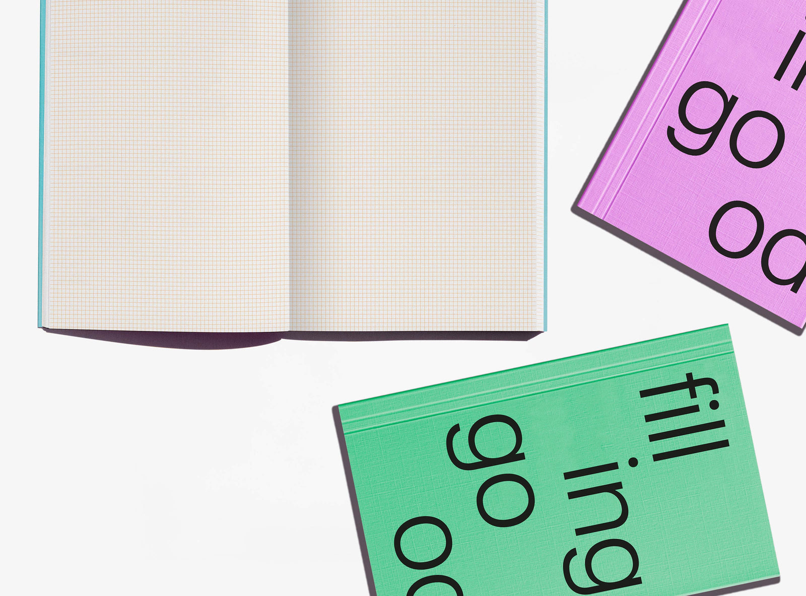 Open notebook with 2mm grid pages and colorful covers on a white background
