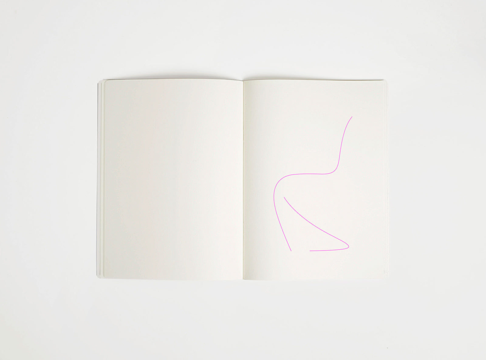 Open notebook with a pink drawing suggesting Panton Chair on white background,  the iconic design piece