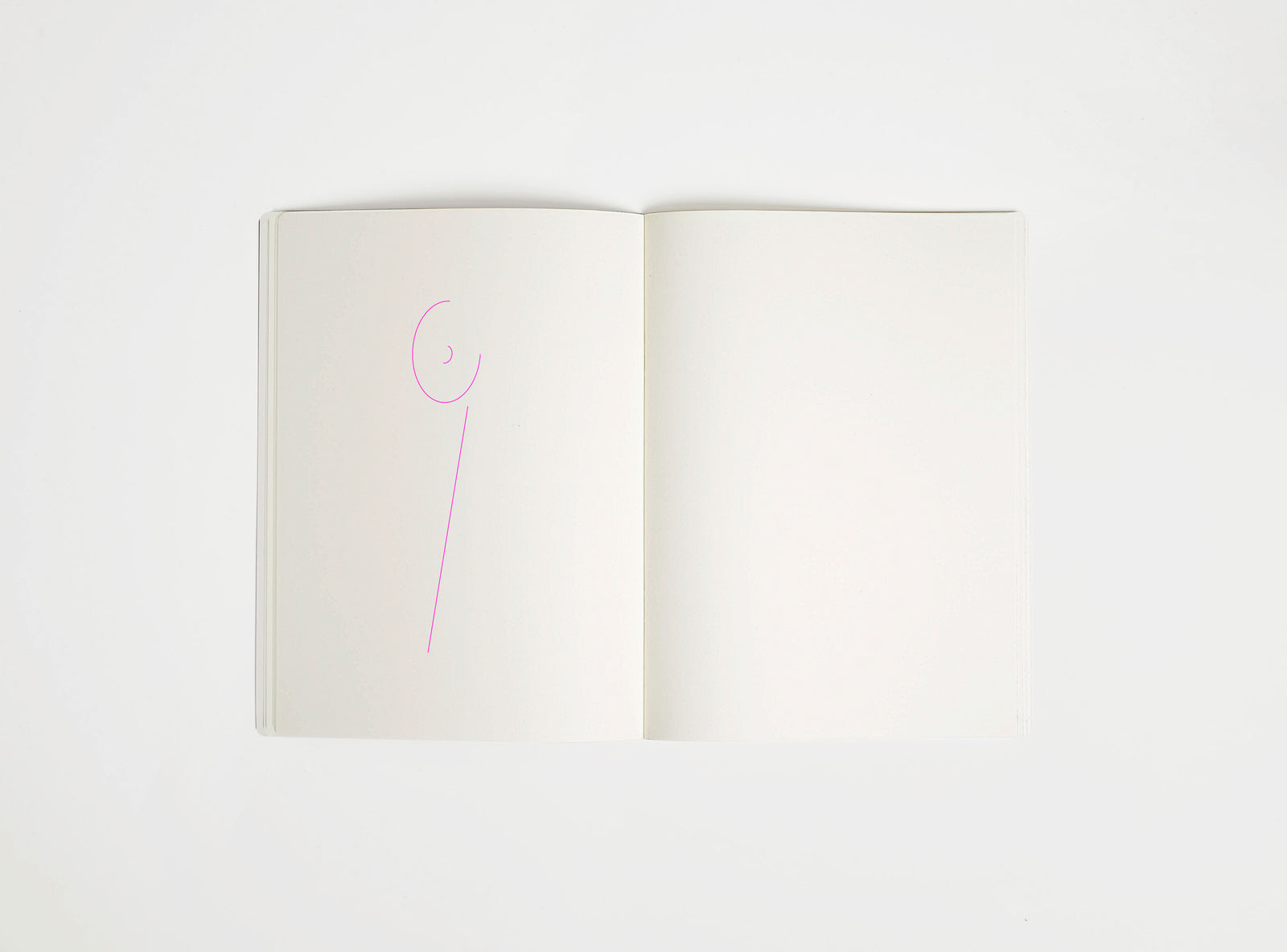 Open notebook with a pink drawing suggesting Sottsass table lamp on white background, the iconic design piece