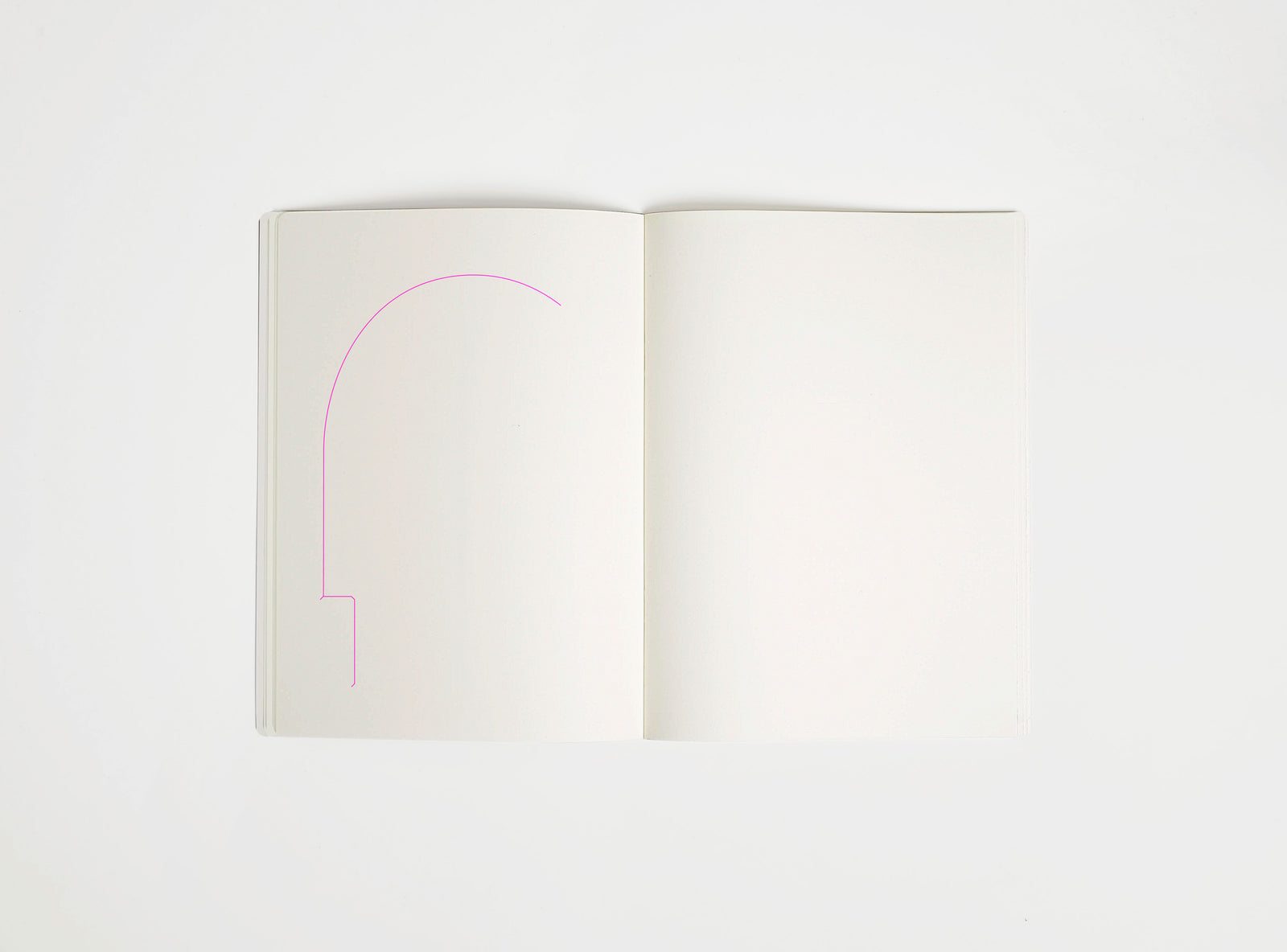 Open notebook with a pink drawing suggesting Arco Lamp on white background, the iconic design piece