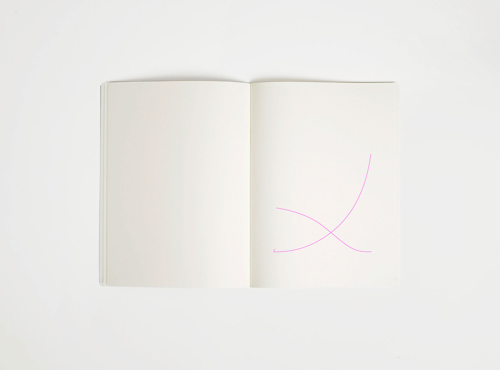 Open notebook with a pink drawing suggesting Mies van der Rohe Barcelona Chair on white background, the iconic design piece
