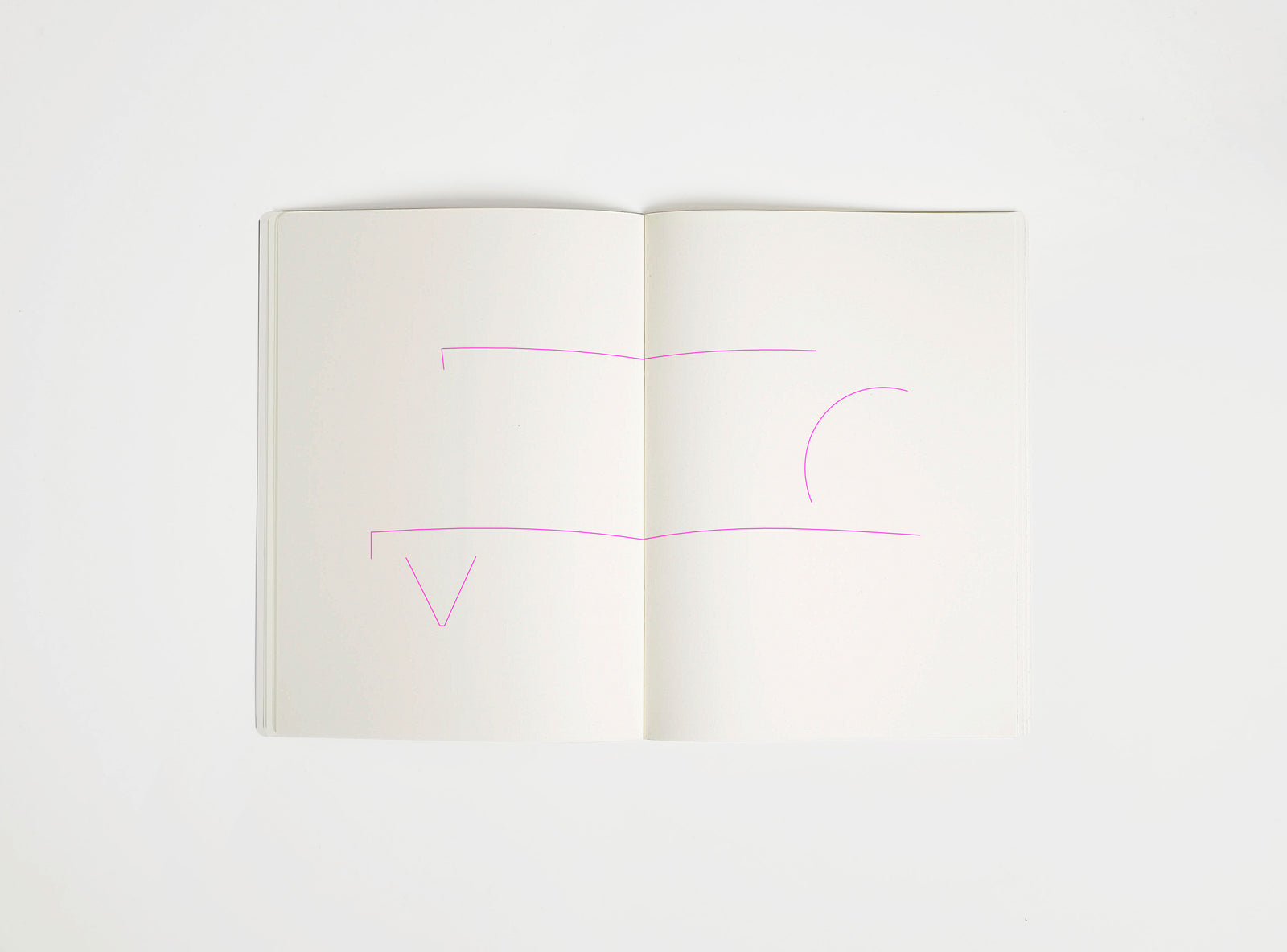 Open notebook with a pink drawing suggesting Memphis Big Sur Sofa on white background, the iconic design piece