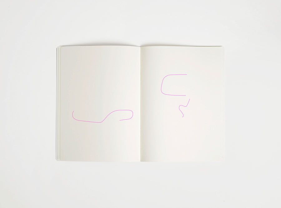 Open notebook with a pink drawing suggesting Eames Chair on white background, the iconic design piece