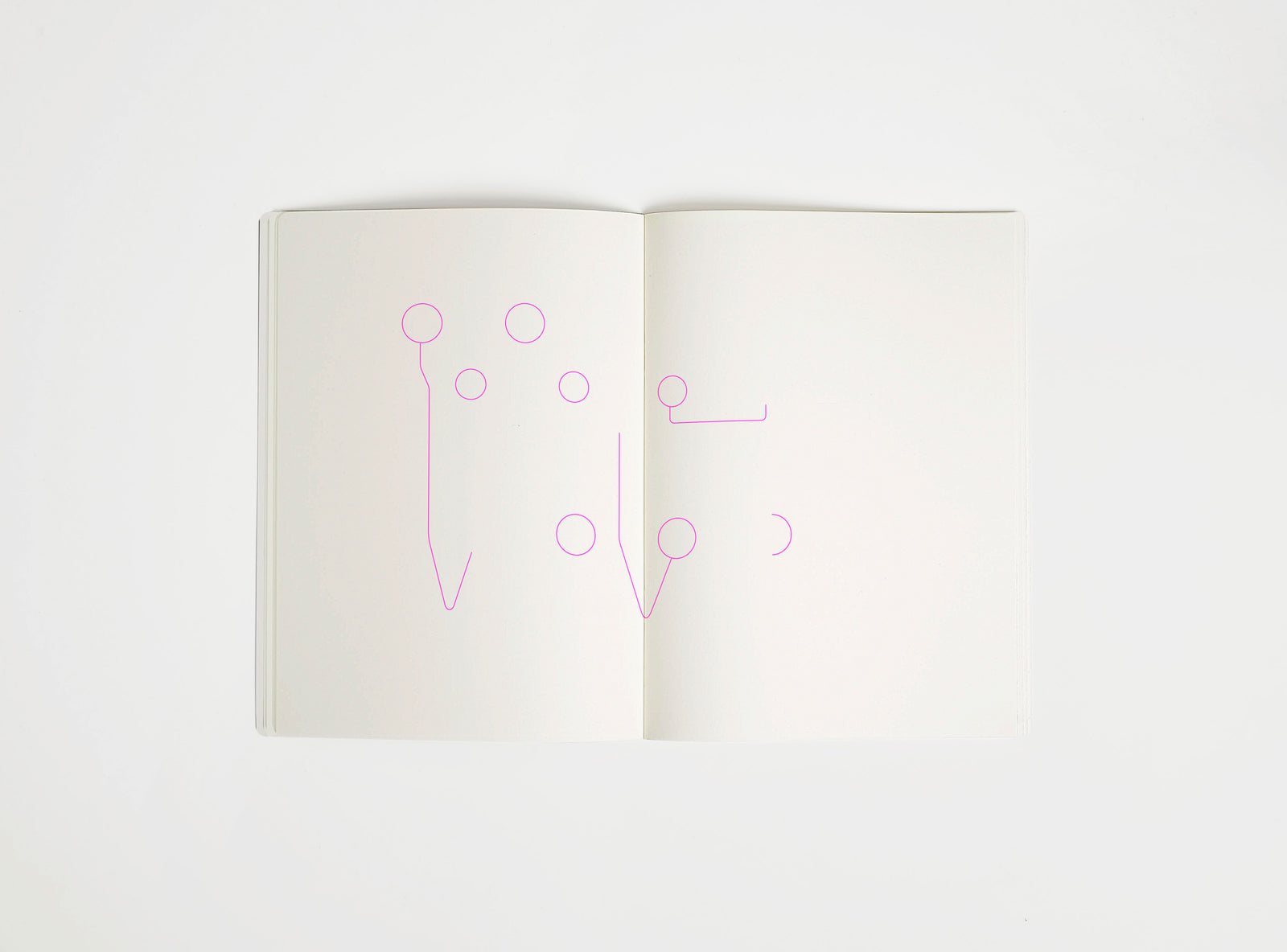 Open notebook with a pink drawing suggesting Eames Hang it All on white background, the iconic design piece
