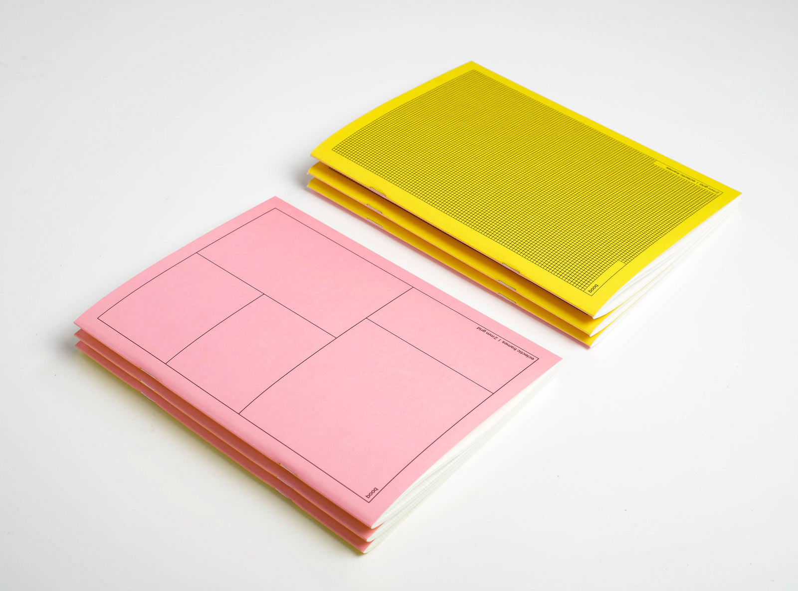 1 pink and on yellow pile of notebooks booq on a white background