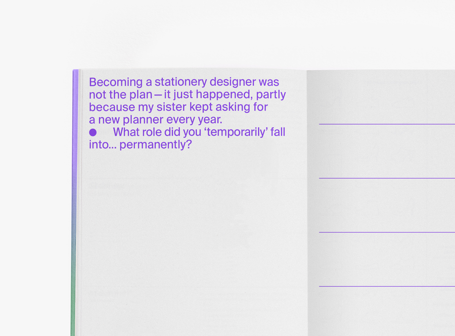 An open edition julie joliat planner agenda 2027 showing a page with purple text on the left and a weekly schedule layout on the right, photographed on a clean white background.