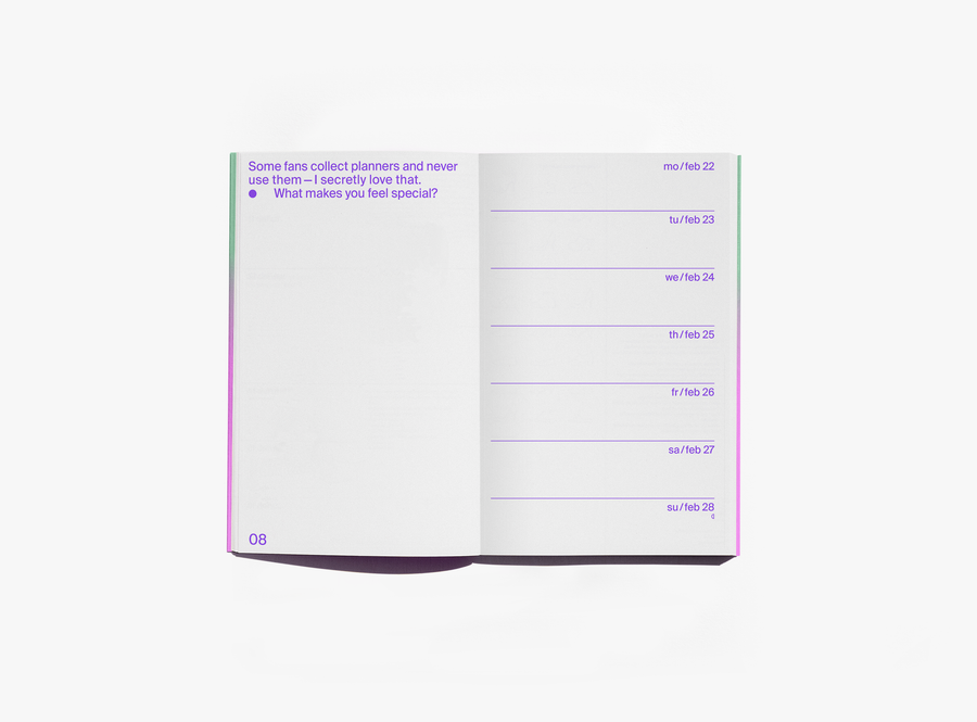 An open edition julie joliat planner agenda 2027 showing a page with purple text on the left and a weekly schedule layout on the right, photographed on a clean white background.