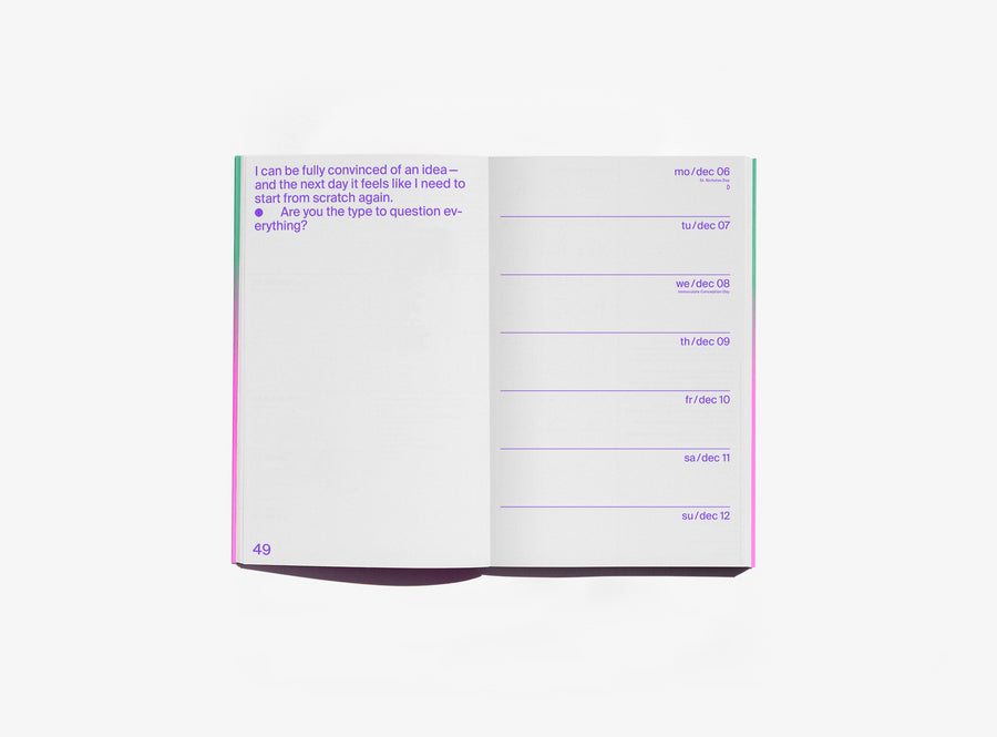 An open edition julie joliat planner agenda 2027 showing a page with purple text on the left and a weekly schedule layout on the right, photographed on a clean white background.