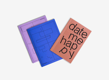 One notebooks with different colored covers and planner date me happy  on a white background