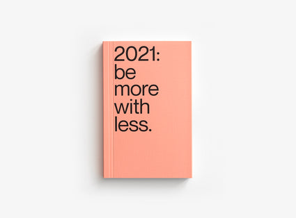 Salmon color cover of our 2021 planner which motto was be more with less.