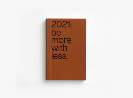 Brown color cover of our 2021 planner which motto was be more with less.