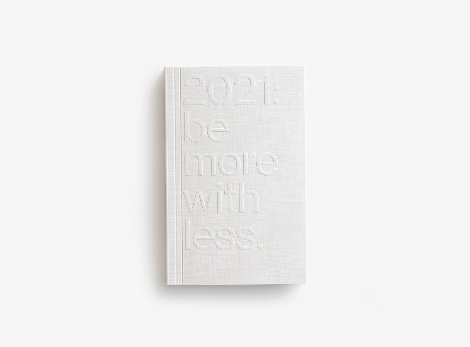 White color cover of our 2021 planner which motto was be more with less.