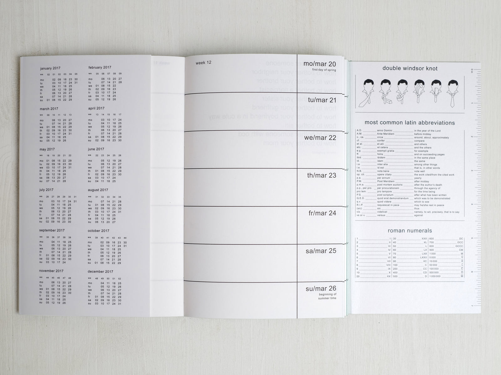 Planner from 2017 with bandanas opened showing the calendar part and other details such as how to make a double Windsor knot, latin abbreviations and roman numerals.